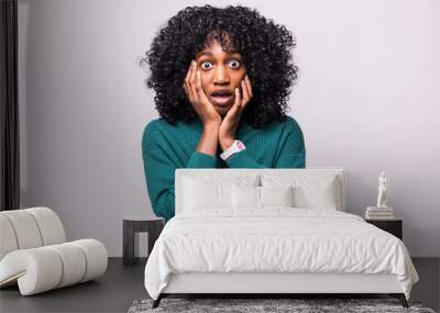 Portrait of beautiful scared young african woman female with curly hairstyle shocked isolated on white background Wall mural